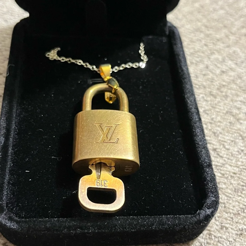 Louis Vuitton lock and key necklace. 18” long. Lock number 319.